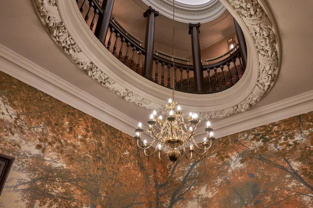 a chandelier hanging from a ceiling in a building at The Capital Hotel, Apartments & Townhouse in London