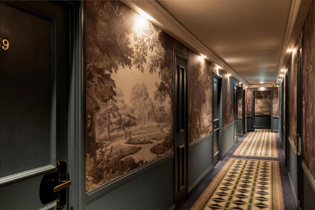 a hallway with a painting on the wall at The Capital Hotel, Apartments & Townhouse in London